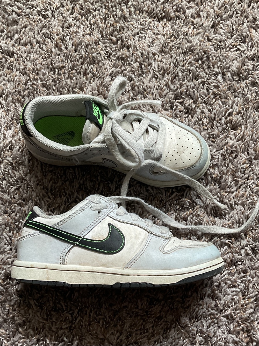 Nike Kids White Low-Top Sneakers with Black Swoosh and Neon Green Accent